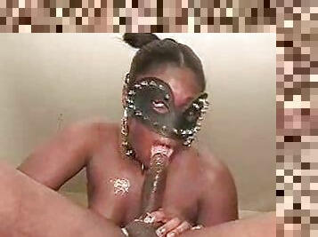 Black slut in a mask sucking black cock