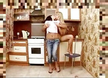 Lesbians fondling in kitchen