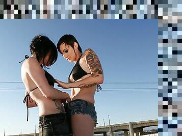 Lesbians on the rooftop get out the strapon for hot sex