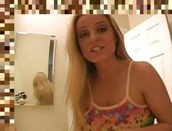 A busty blonde in a tight shirt brushing her teeth