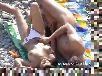 Cute brunette sucks a cock at the beach not knowing about a voyeur