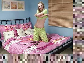 A cute girl in pajamas dildates herself in bedroom