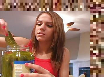 Bad teen tries to look horny playing with a pickled cucumber
