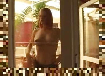 Redhead milks her tits all over the window