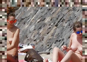 Topless beach hotties relax in sunglasses