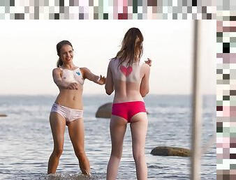Superb girls play together by the beach in really erotic manners