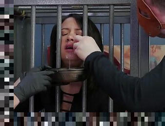 Caged slave girl sucks on a cum ice cube