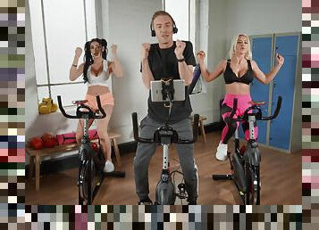 Sporty bitches get intimate during spinning class and devour the same cock together