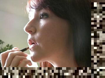 Amateur teen putting lip balm on her lips on webcam