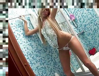 A tall, sexy blonde takes dildo into the shower and plays