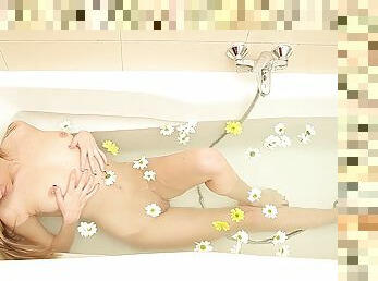 Cute long-haired girl enjoys playing with her pussy in the bathtub