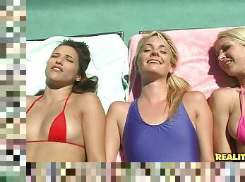 Three pretty babes make some lesbian love on a rooftop