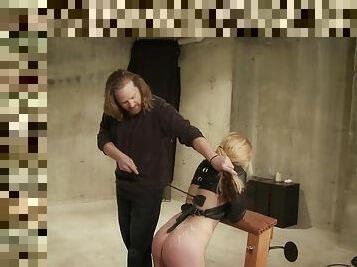 Bondaged slut endures spanking and torture with a dildo pole