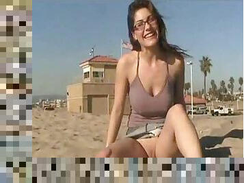 Girl in glasses showing naughty parts at beach