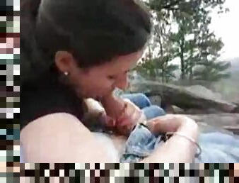 Couple outdoors while the girl sucks him