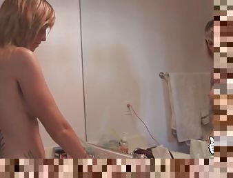 Naked Tricia Oaks does her hair in the bathroom