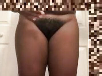 Ebony teen oils up naked body after shower