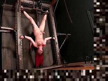 Redhead hangs upside down in sexy bondage