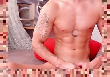 Jerking hot with a vibration toy close -up. Muscles, ABS and perfect dick