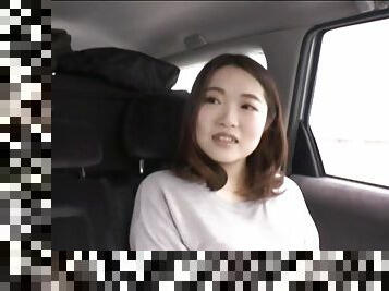 Asian wife takes a vibrator and pleasures her pussy in the car