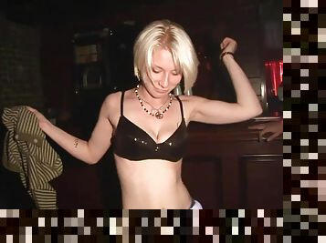 Tattooed drunk amateur in miniskirt dancing wildly in a club party in reality shoot