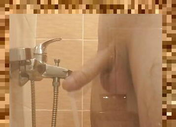 A young guy washes in the shower and plays with his dick