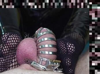 My feet in fishnet socks tease his chastity belt