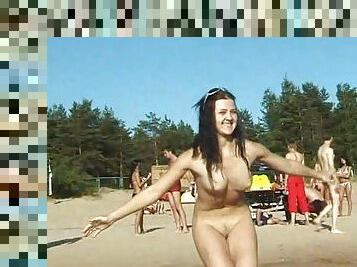 Slim teen with perky boobs naked at a nudist beach