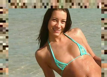 Petite teen in a green bikini masturbate on the beach