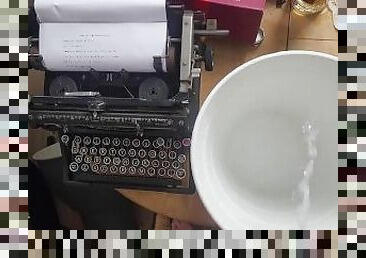 Pissing in the bucket next to typewriter spilling on the table